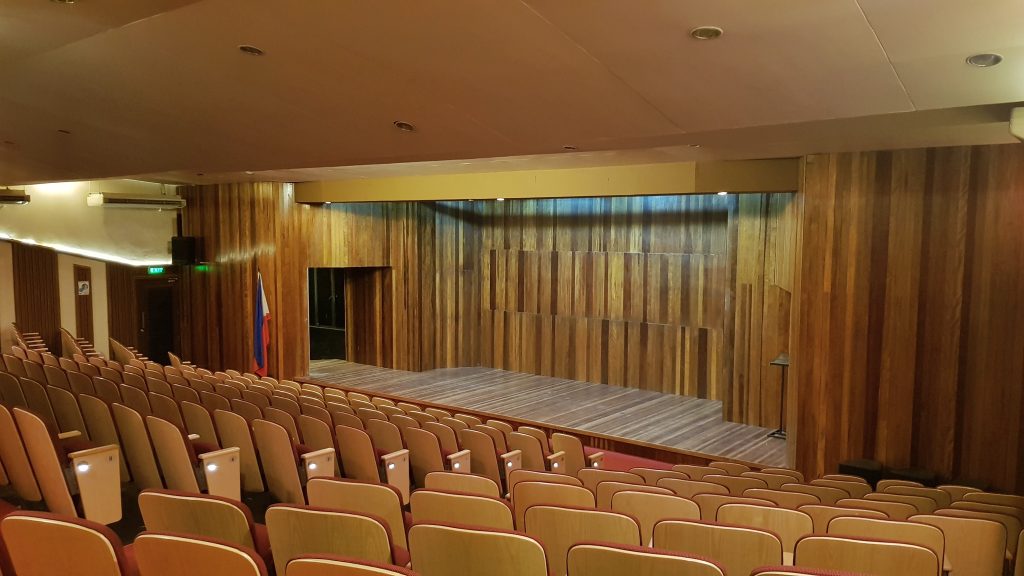 Recital hall with chairs and stage made of wood